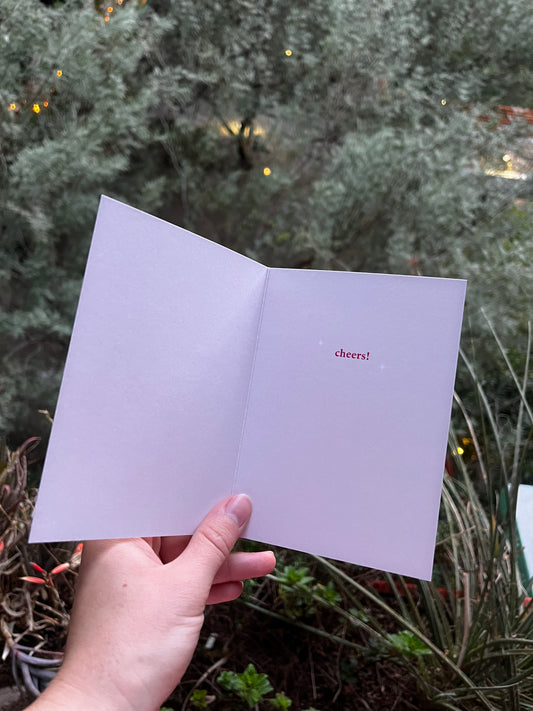inside of a birthday card that says "cheers!"
